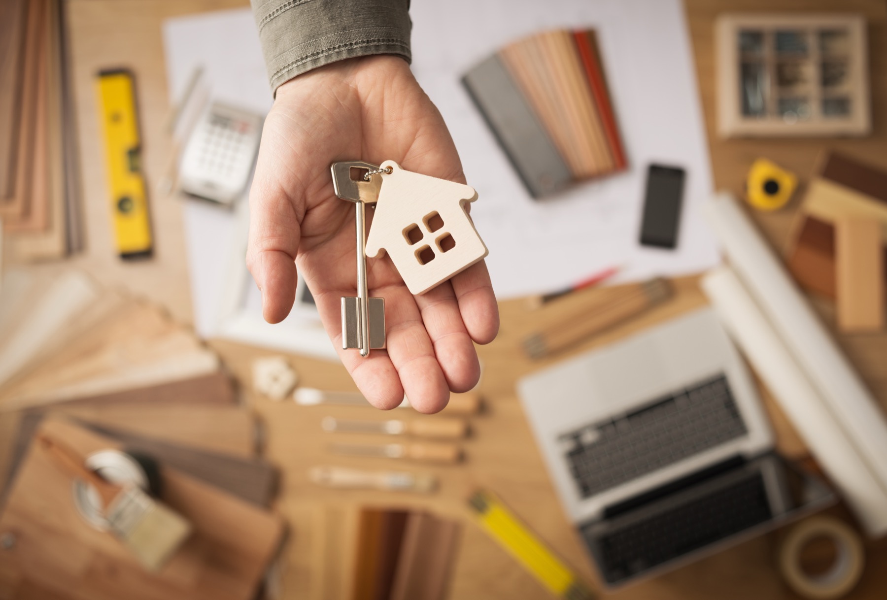 Hand holding house keys
